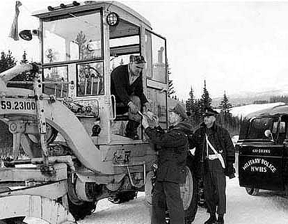 Civilian worker receiving his pay while on the job.