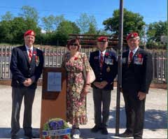 Carol Kohler Scotti and Canadian soildiers before the monument.